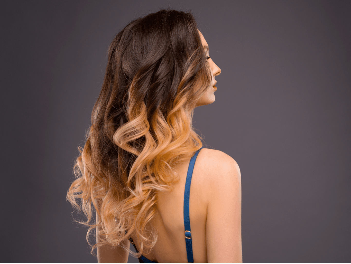 Woman with warm brunette-to-blonde half head balayage at Michael Todd Hairdressing, East Grinstead — expert soft-blend colour services for dimension and brightness in West Sussex