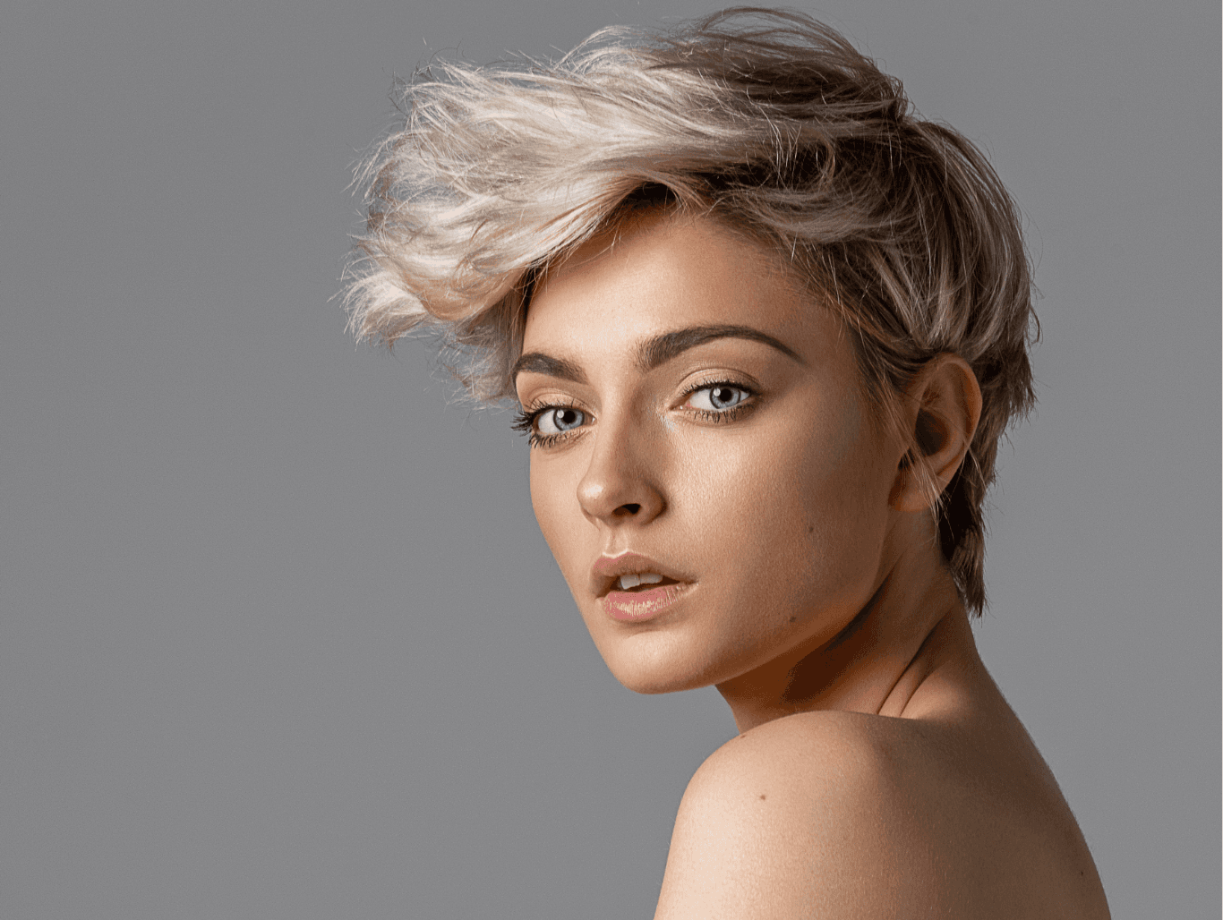 Woman with soft platinum highlights and short textured haircut, styled naturally – Michael Todd Hairdressing