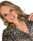 Katie Quy, Senior Stylist at Michael Todd Hairdressing in East Grinstead, showcasing her signature bouncy curls and warm smile, wearing a stylish animal print blouse.