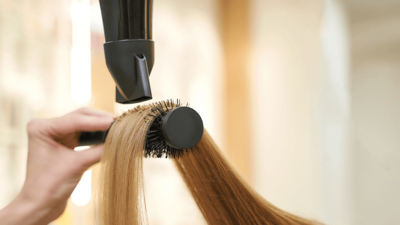 Close-up of long hair being blow-dried with a round brush at Michael Todd Hairdressing, East Grinstead — expert shampoo and blowdry service for long hair in West Sussex