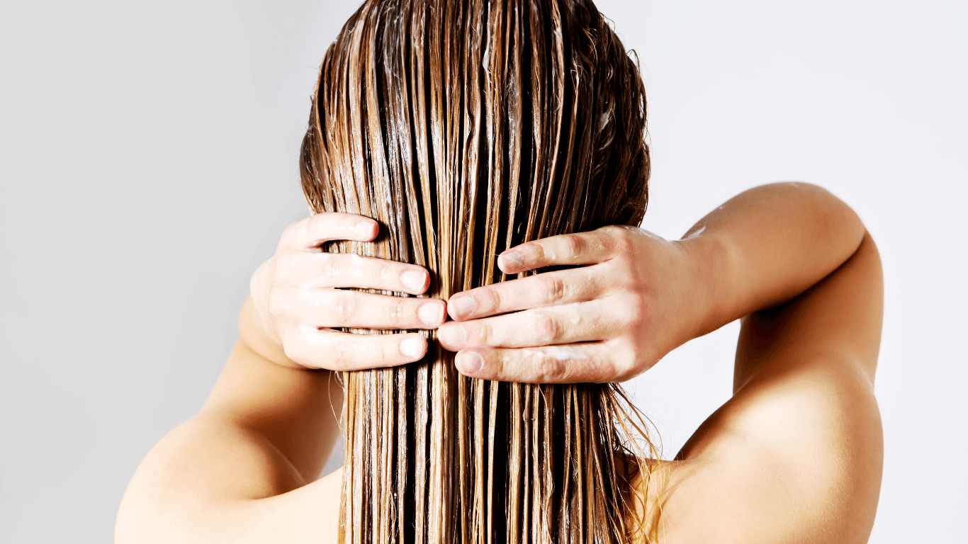 Woman with glossy, healthy hair after professional treatment at Michael Todd Hairdressing, East Grinstead, showcasing expert nourishing services for West Sussex clients